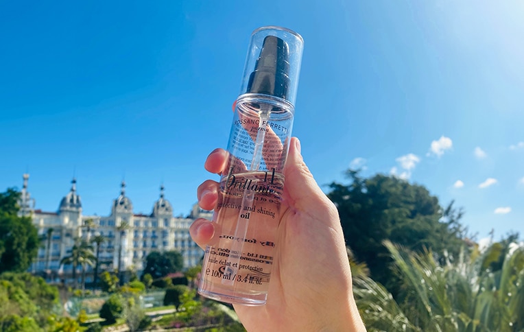 Image of a girl holding Rossano Ferretti Parma's Brillante protect and shine oil