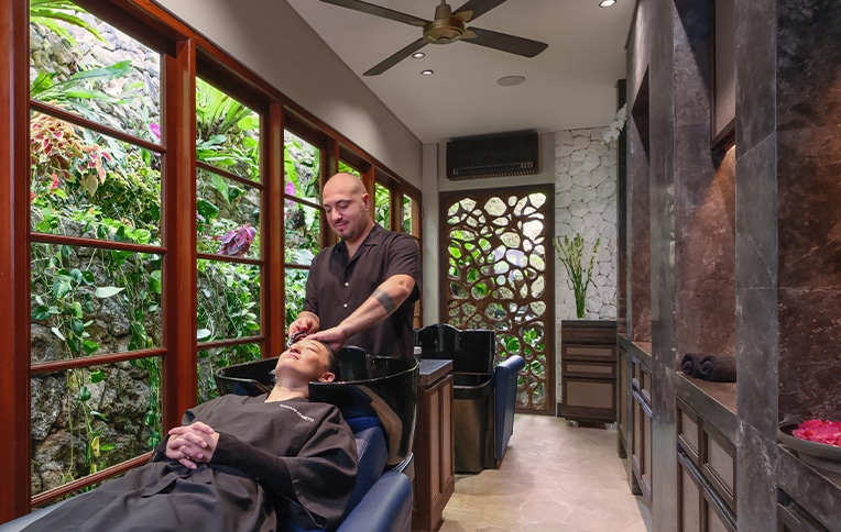 Girl getting her hair washed at a hair salon station.