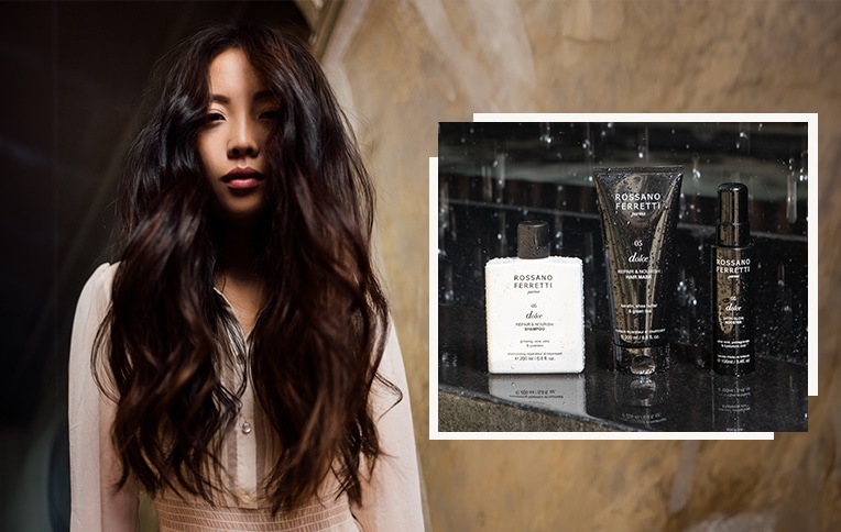 Rossano Ferretti Parma's Dolce nourishing routine includes the nourishing shampoo, the repair and nourish mask, and the satin glow booster spray, showcased alongside a girl with long, dark, and wavy hair.