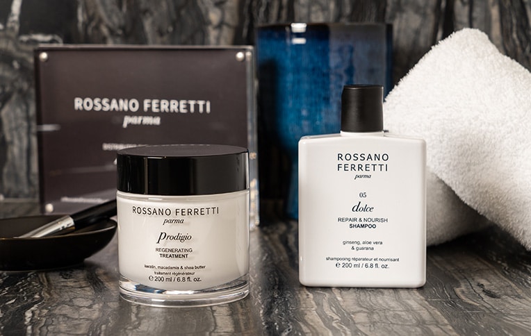 Image of the regenerating pre-shampoo treatment from the Prodigio line and the repair & nourish shampoo from the Dolce line by Rossano Ferretti Parma.
