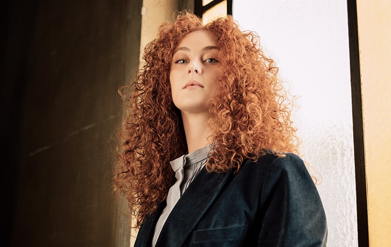 Image of a girl with long, curly red hair.