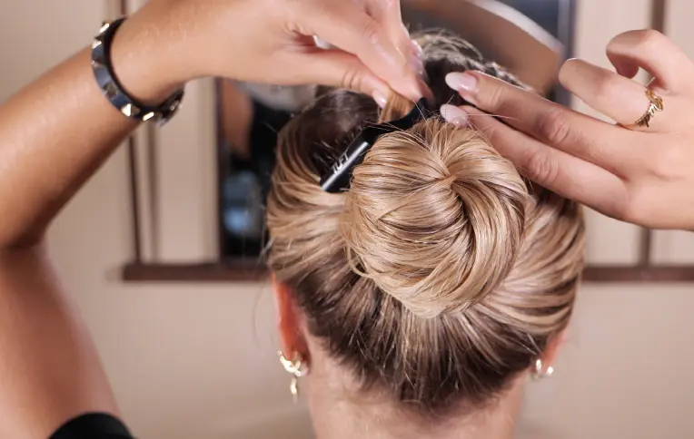 Blonde girl applying a hair mask