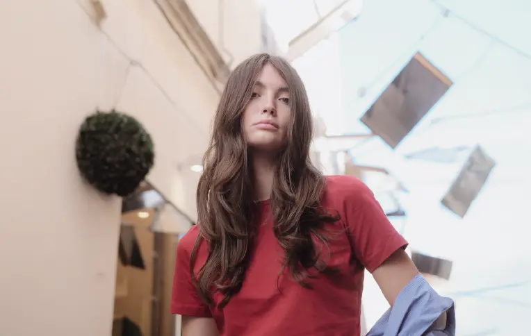 Brunette girl with long, wavy hair.