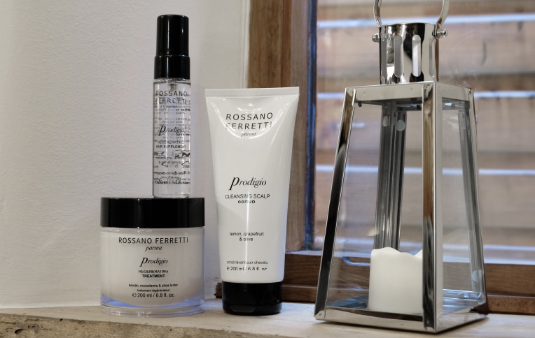 Image of Rossano Ferretti Parma's Prodigio collection with the cleansing scalp scrub, the regenerating treatment and the regenerating oil.