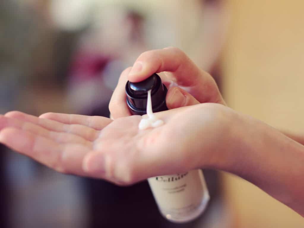 Image of a girl applying some of the Velluto smoothing serum by Rossano Ferretti Parma onto her hand.