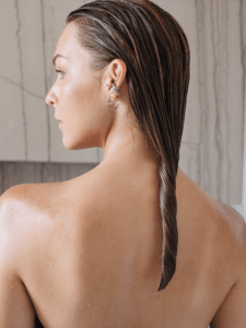 Image of a blonde girl with wet hair in a bathroom.