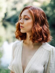 Image of a girl with short, wavy red hair.