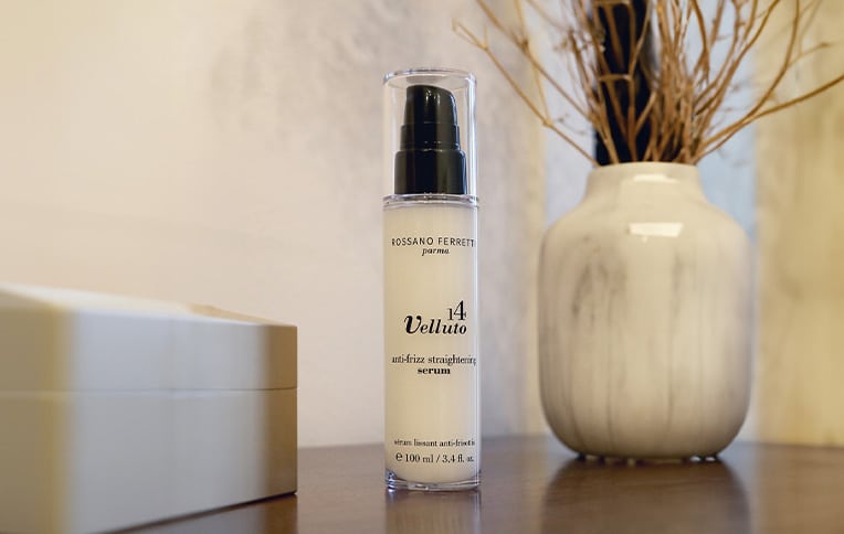 Image of the Anti-Frizz Straightening Serum Vita by Rossano Ferretti Parma with a plain background and a vase