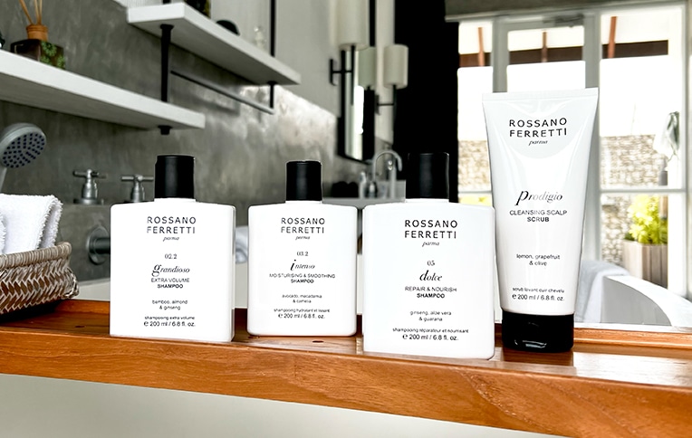 Image of Rossano Ferretti Parma's shampoos. Featuring: Grandioso volumizing shampoo, Intenso moisturising & smoothing shampoo, Dolce nourishing shampoo, Prodigio scalp scrub.