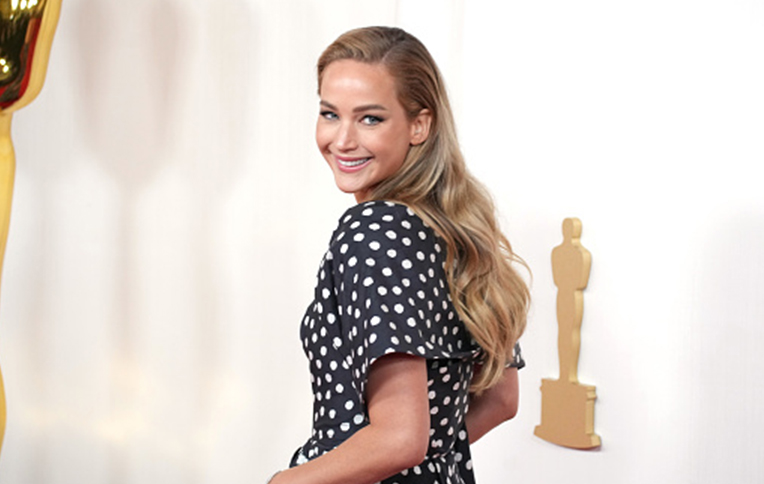 Photos of Jennifer Lawrence at the 2024 Oscars Red Carpet, showcasing her effortless waves.
