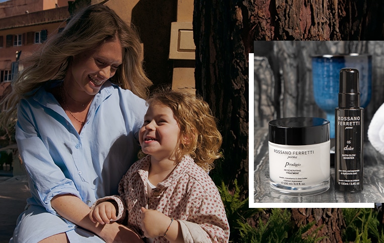 Image of a girl with long, wavy blonde hair and a little girl with curly blond hair alongside Rossano Ferretti Parma's Prodigio regenerating treatment and Dolce Satin Glow Booster.