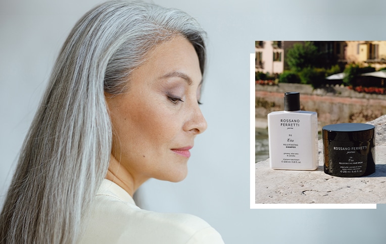 Image of a woman with long, straight gray hair alongside Rossano Ferretti Parma's Vita rejuvenating shampoo and mask.