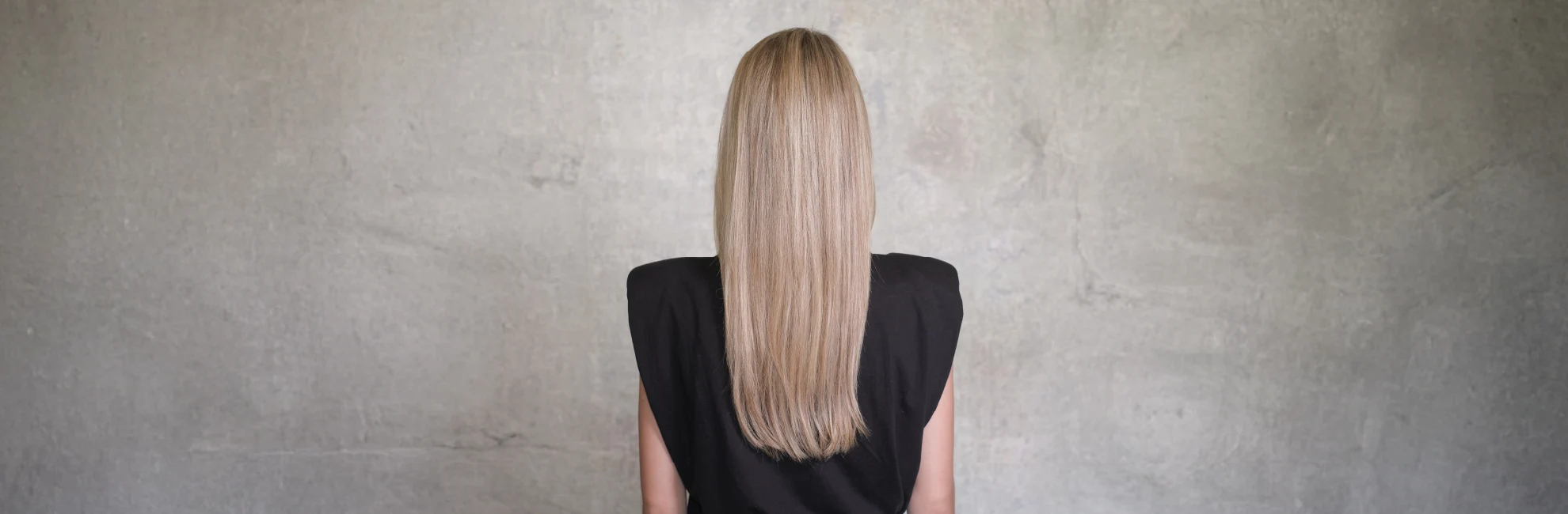 Blonde long hair woman grey background