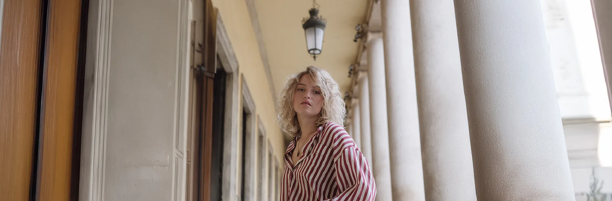 Blonde woman in red and white stripe shirt