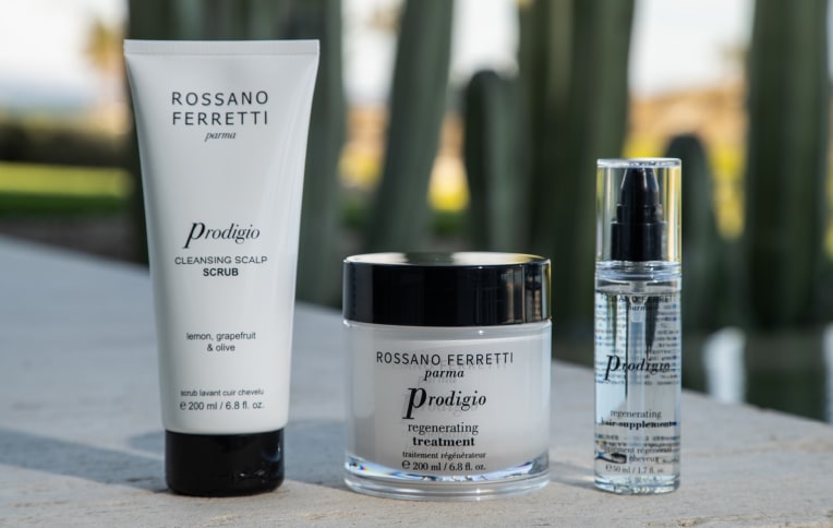 Image of Rossano Ferretti Parma's Prodigio collection with the cleansing scalp scrub, the regenerating treatment and the regenerating oil.